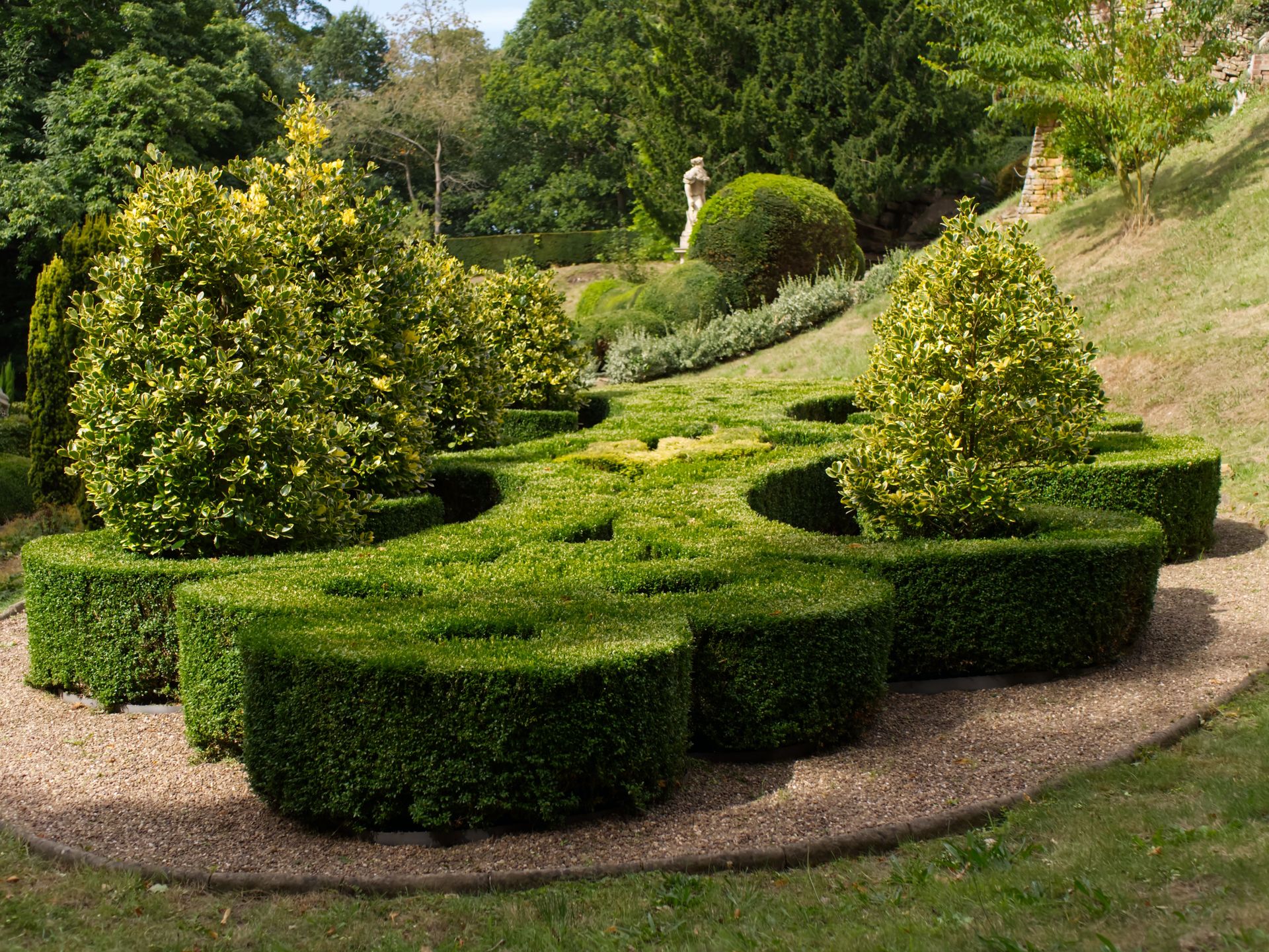A beautifully designed topiary garden with lush greenery and artistic shrub formations.